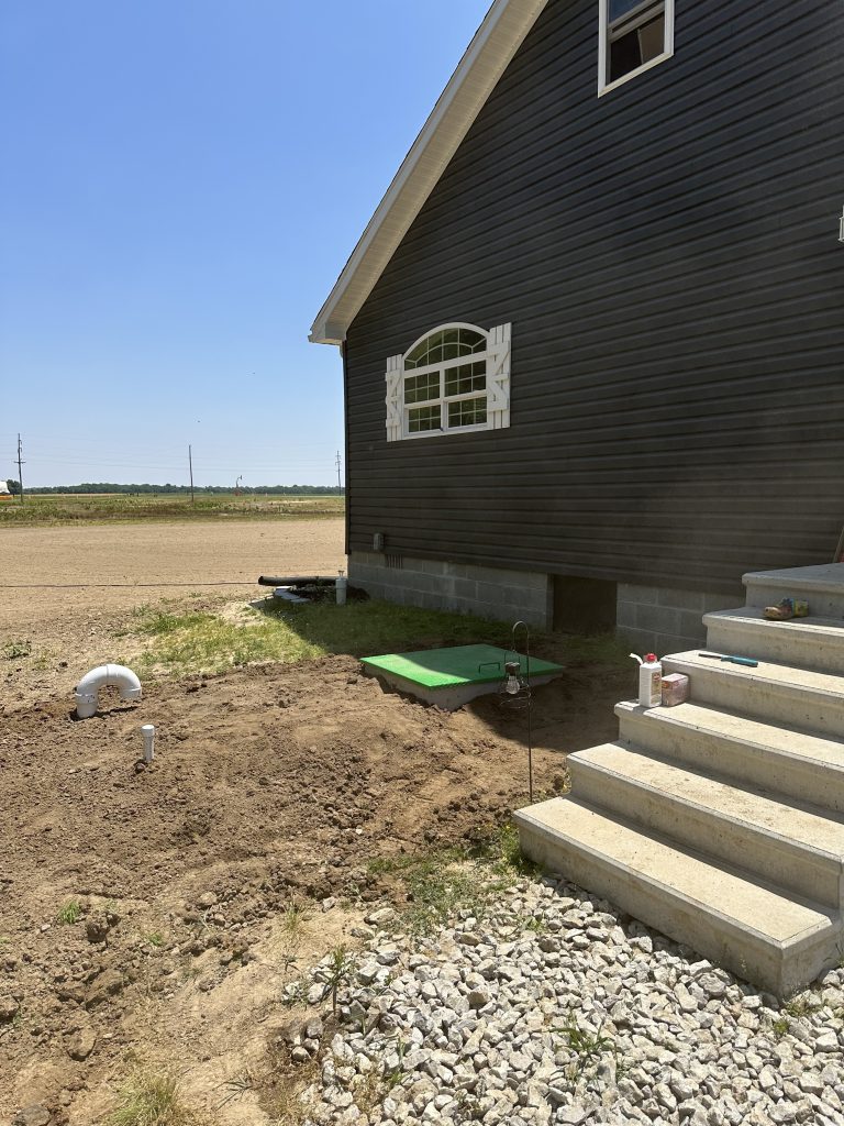 installed top hatch storm shelter right next to house